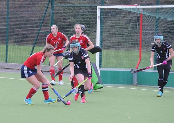 Action from City of Peterborough Ladies seconds (red) and Bourne Deeping firsts. Photo: David Lowndes.