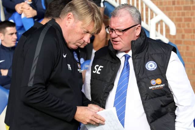 Assistant manager Paul Raynor (left) has given Posh boss Steve Evans a glowing report on AFC Wimbledon.