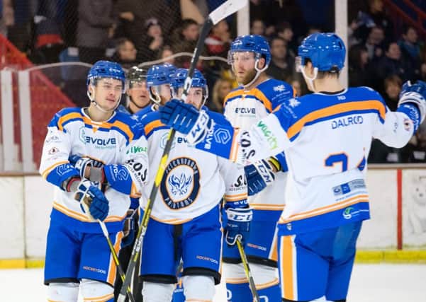 Corey McEwen  (left) celebrates with team-mates after opening the scoring against Invicta.