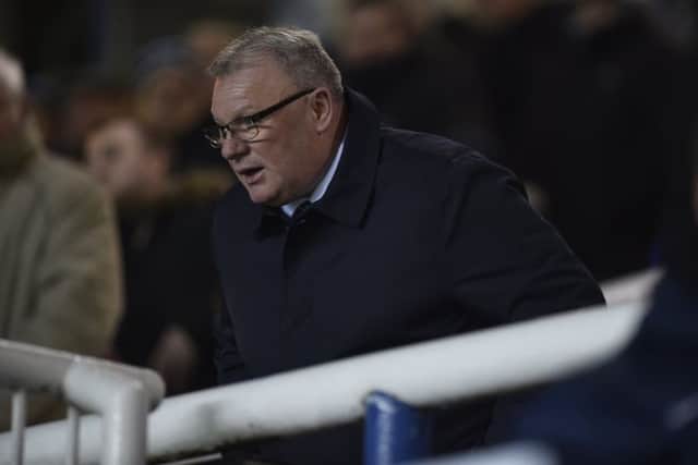 Posh boss Steve Evans watches the game against Wimbledon from the directors box. Photo: David Lowndes.
