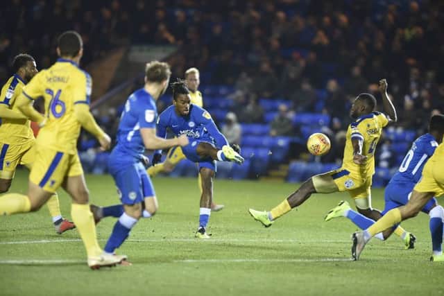 Posh striker Ivan Toney shoots at the Wimbledon goal. Photo: David Lowndes.