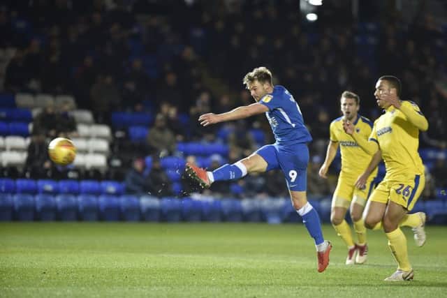 Posh striker Matt Godden shoots at goal against Wimbledon. Photo: David Lowndes.