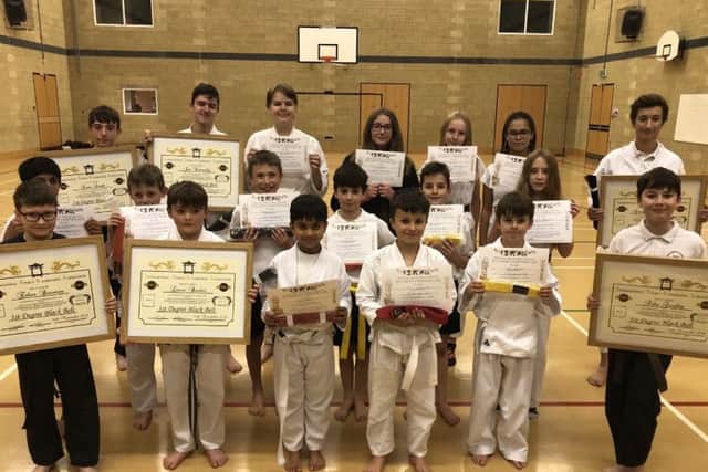 Six of the Clifton Findley students to attain black belt status are pictured  with some of his other students who upped their grade.