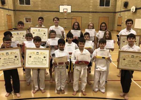 Six of the Clifton Findley students to attain black belt status are pictured  with some of his other students who upped their grade.