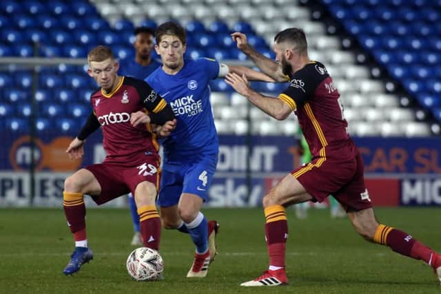Alex Woodyard of Posh in the thick of the battle against Bradford City. Photo: Joe Dent/theposh.com.
