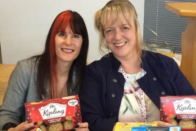 Linden Homes Midlands Sharon Wright with Sam Stokes,  Children and Family Welfare Benefits Advisor at Disability Peterborough with the generous donations for the Christmas appeal.