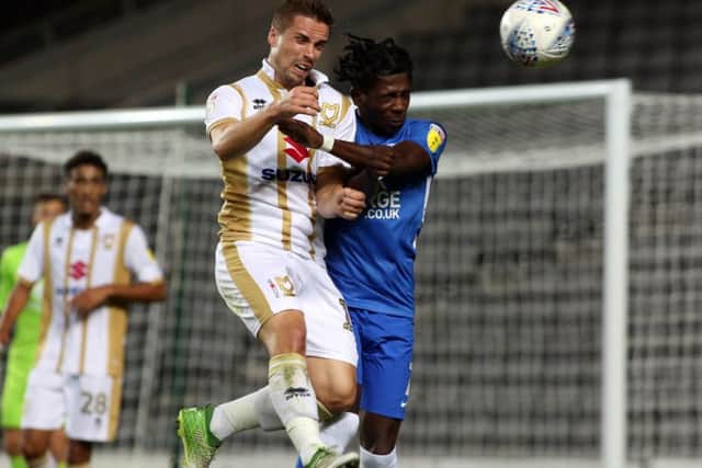 Posh winger Isaac Buckley-Ricketts (right) in action against MK Dons in a Checkatrade Trophy game.