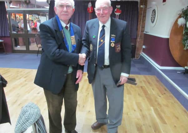 New Peterborough League president Gordon Stirman (left) received the chain of office from outgoing president Dick Gill.