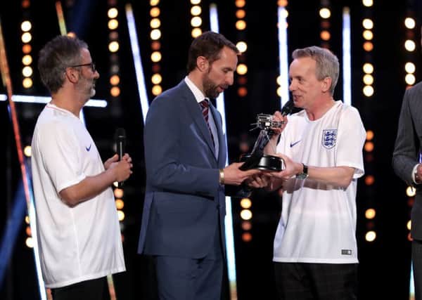 Gareth Southgate receives the coach of the year prize from two clapped out comics.