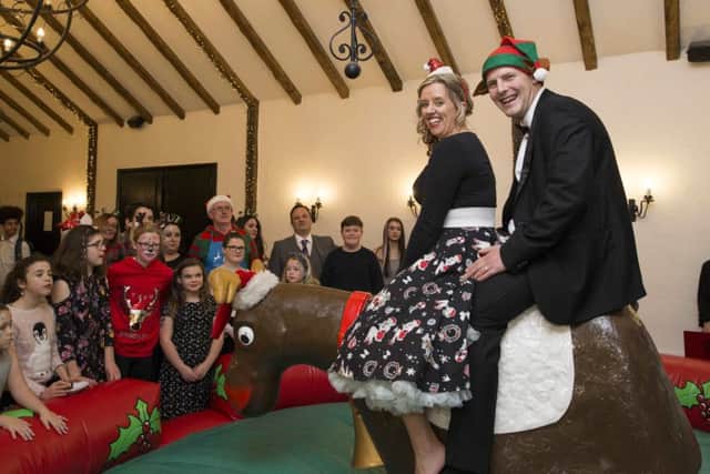 Charlotte and Daniel Peart help put on a party for the young carers. Copyright: Camelot