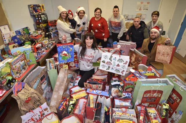 Carly Peachey (centre) with staff from the Venture Pub Company presenting Christmas gifts to the Spurgeons Children's Charity at Honeyhill and Orton Children's Centre at Paston EMN-181218-155359009
