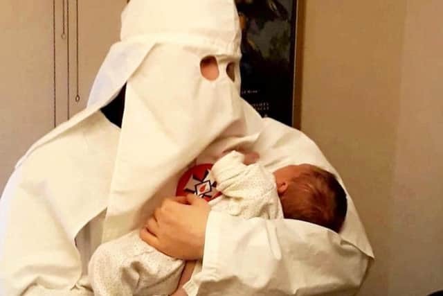 Adam Thomas andClaudia Patatas also posed with their newborn son standing next to a Swastika flag while wearing Ku Klux Klan robes. SWNS.
