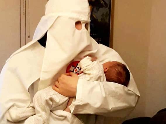 Adam Thomas andClaudia Patatas also posed with their newborn son standing next to a Swastika flag while wearing Ku Klux Klan robes. SWNS.