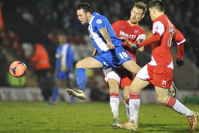 Lee Tomlin in action for Posh in 2014.