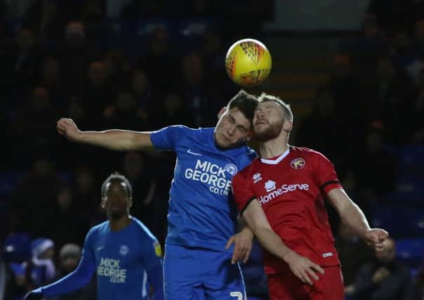 Mathew Stevens of Peterborough United challenges for the ball with Nicky Devlin of Walsall. Photo: Joe Dent/theposh.com.