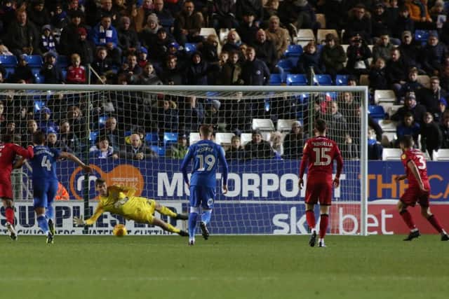 Posh goalkeeper Conor O'malley dives to save a penalty from Luke Leahy. Photo: Joe Dent/theposh.com.