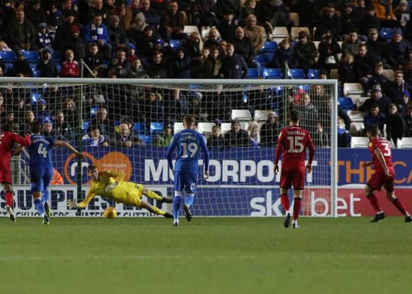 Posh goalkeeper Conor O'malley dives to save a penalty from Luke Leahy. Photo: Joe Dent/theposh.com.