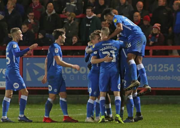 Ivan Toney is mobbed by teammates after completing his hat-trick at Accrington. Photo: Joe Dent/theposh.com.