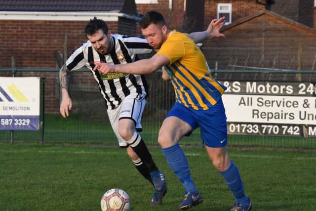 Matthew Barber of Peterborough Northern Star (stripes) in action against Wellingborough Town. Photo: Chantelle McDonald. @cmcdphotos.