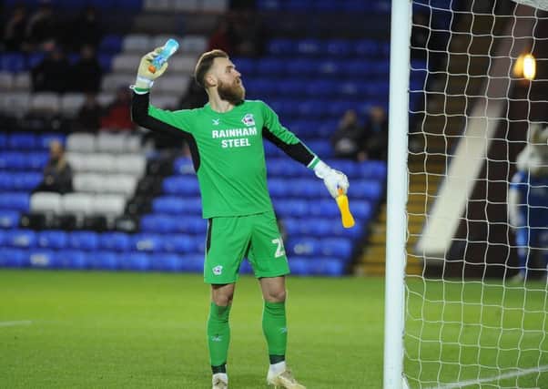 Scunthorpe goalkeeper Jak Alnwick feigns to throw a bottle back into the Posh crowd. Photo: David Lowndes.