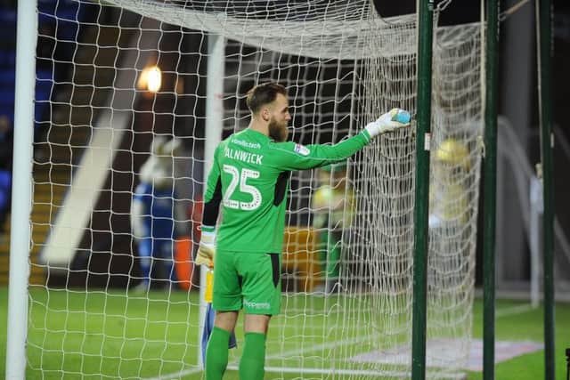 Scunthorpe goalkeeper Jak Alnwick drops a plastic bottle behind his goal. Photo: David Lowndes.
