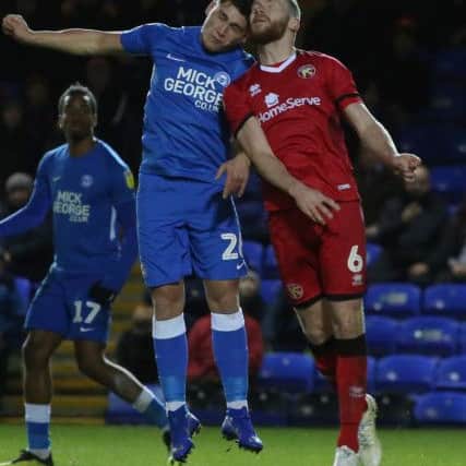 Mathew Stevens of Peterborough United challenges for the ball with Nicky Devlin of Walsall. Picture: Joe Dent