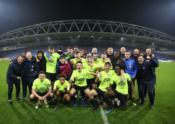 The Posh youth team squad celebrate their win at Huddersfield.
