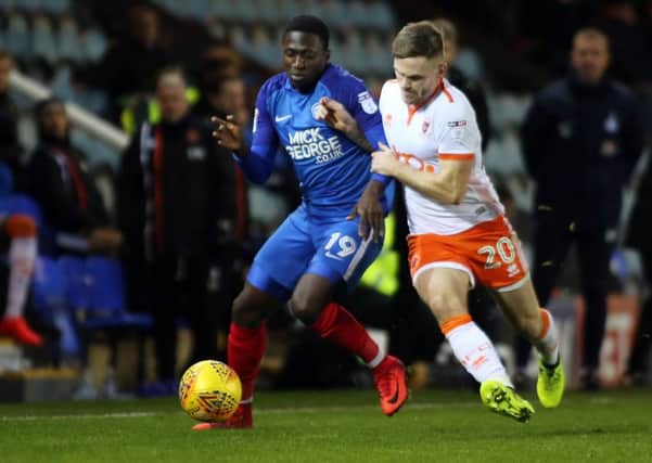 Idris Kanu (left) in action for Posh.