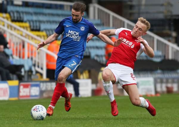 Kyle Dempsey (right) in action for Fleetwood against Posh last season.