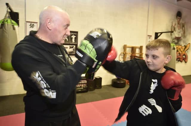 MPSK martial arts Master Ian Parker   with Jake Parker-White at  martial arts classes for children with additional needs at  MPSK, Bretton. EMN-190801-184412009