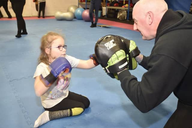 MPSK martial arts Master Ian Parker   with  Rebecca Stannard (10) at  martial arts classes for children with additional needs at  MPSK, Bretton. EMN-190801-184434009