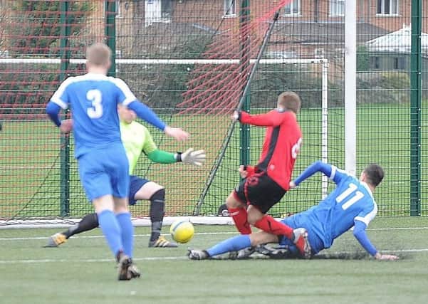 Action from Netherton United's Peterborough Senior Cup defeat at the hands of Whittlesey Athletic (blue) last weekend.