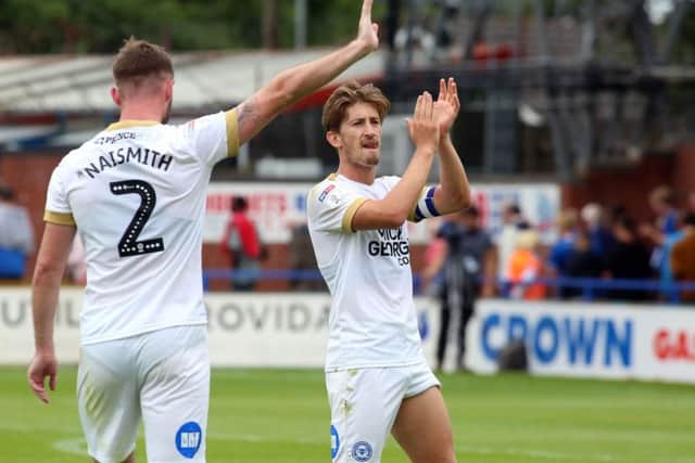 Posh skipper Alex Woodyard applauds the visiting fans after a 4-1 win at Rochdale in August.