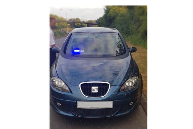 The car, fitted with blue lights, Davidson used
