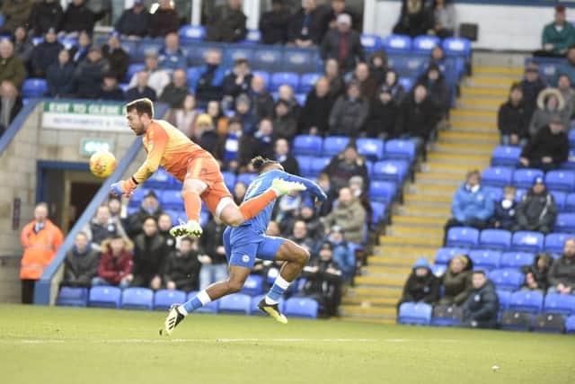 Rochdale goalkeeper Josh Lillis just beats Posh striker Ivan Toney to the ball. Photo: David Lowndes.
