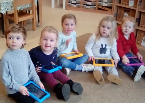 Youngsters at Barnack Preschool with their new tablet computers