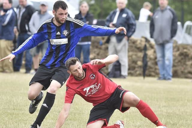 Stilton United (red) in action earlier this season.
