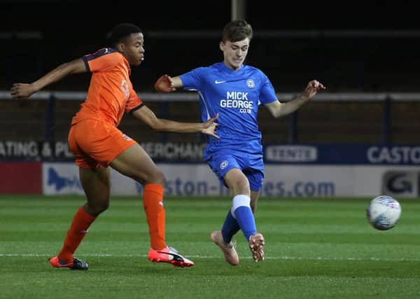Harrison Burrows (right) in action for Posh youths,