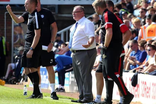 Rival managers Steve Evans and Grant McCann watch Posh v Doncaster in September.