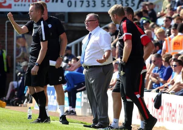 Rival managers Steve Evans and Grant McCann watch Posh v Doncaster in September.