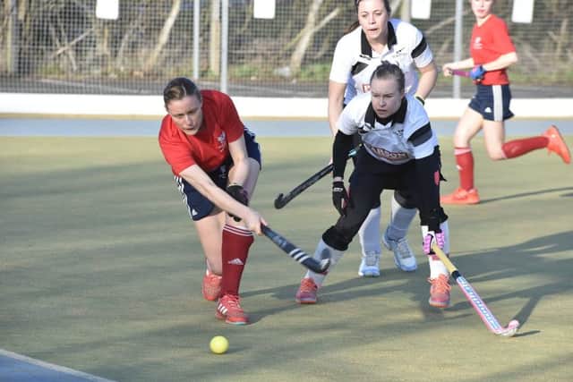 Verity Allen of City of Peterborough mixed hockey team (red) in action at Bretton Gate against Harleston. Photo: David Lowndes.