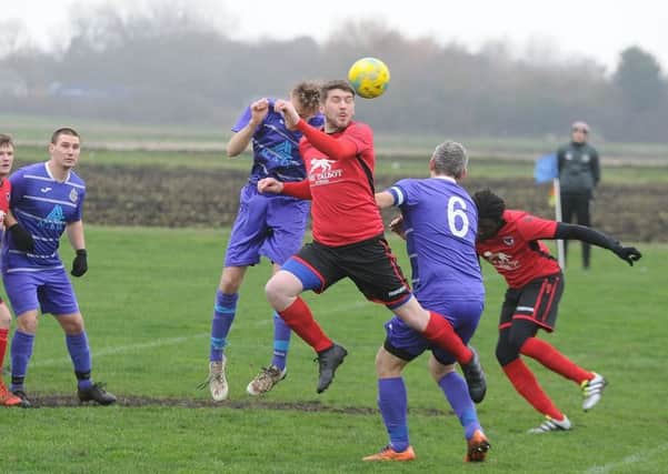 Action from Stilton United (red) and NECI in the quarter-final of the Peterborough Junior Cup. Photo: David Lowndes.