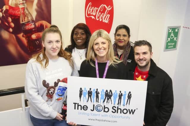Rosie King, Coca Cola Contact Centre Team Leader, middle, flanked by members of the Contact Centre team
at their office in Morley Way, Woodston, Peterborough.