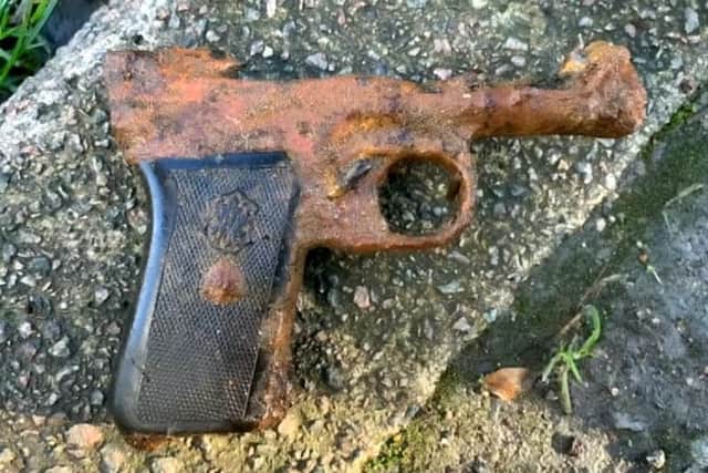 Nigel Lamford, 47, has recovered more than 20 guns and grenades - as well as wartime bullets - from a ten mile stretch of the River Nene. Photo: SWNS