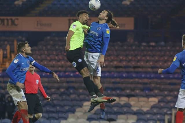 Posh centre-back Rhys Bennett in action with Christian Burgess of Portsmouth. Photo: Joe Dent/theposh.com.