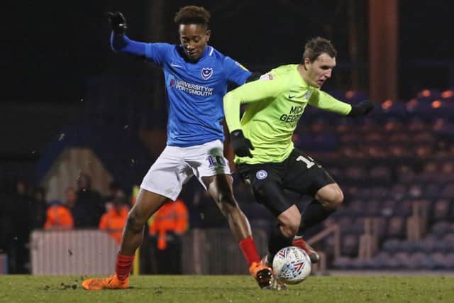 Callum Cooke of Peterborough United in action with Jamal Lowe of Portsmouth. Photo: Joe Dent/theposh.com.