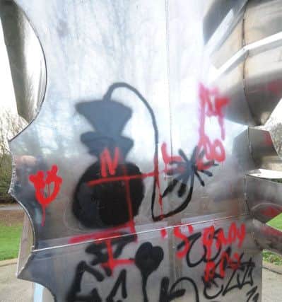 Graffiti painted on the steel sculpture near Frank Perkins Parkway. EMN-190122-150540009