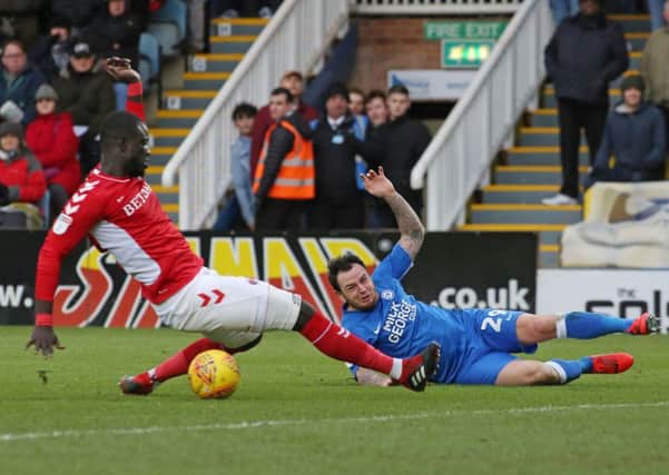 Lee Tomlin of Posh in action with Mouhamadou Naby Sarr of Charlton. Photo: Joe Dent/theposh.com.