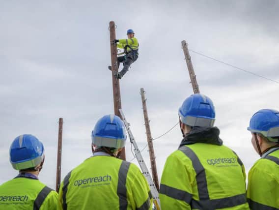 Trainee engineers at work in one of the fields of poles at the Peterborough training school.