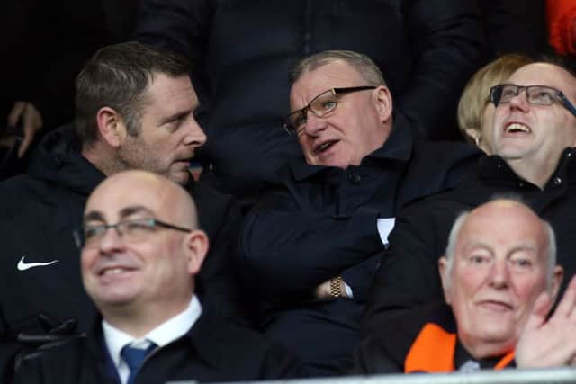 Posh chairman Darragh MacAnthony (left) with Steve Evans at Luton on January 19.